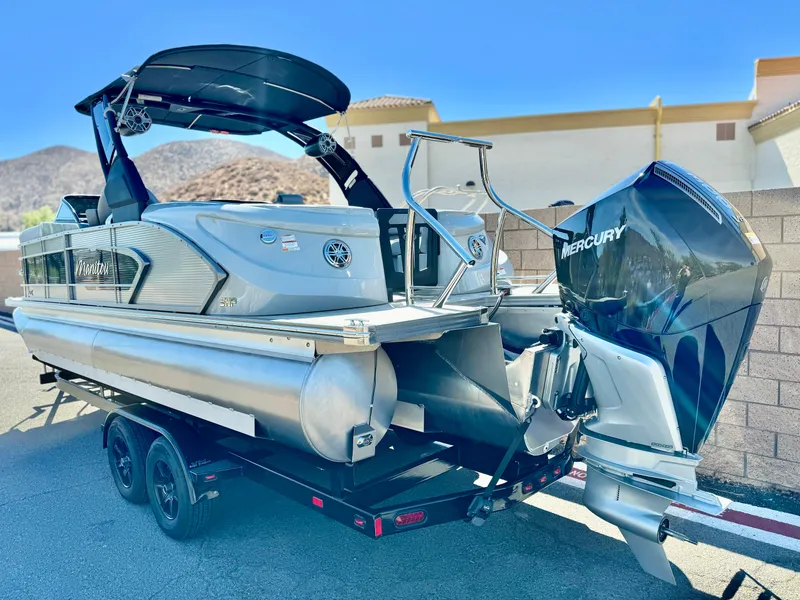Slide: The Image of 2025 Manitou 23 LX RFXW pontoon boat with Mercury engine on trailer. - 7