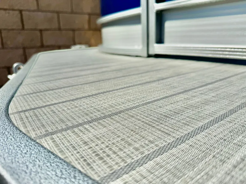 Slide: The Image of Close-up of 2025 Manitou 23 LX RFXW boat deck with textured surface. - 9