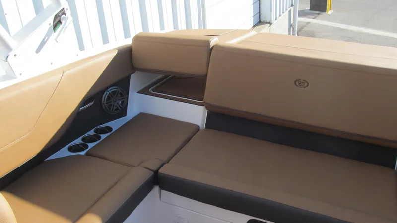Slide: The Image of 2025 Cobalt CS23 boat interior with tan seating and cup holders. - 13