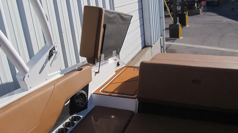 Slide: The Image of 2025 Cobalt CS23 boat interior with tan seating and storage compartments. - 14