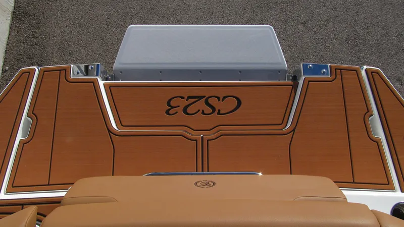 Slide: The Image of 2025 Cobalt CS23 boat deck with stylish wood finish and logo. - 17