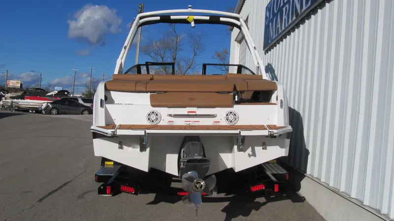 Slide: The Image of 2025 Cobalt CS23 boat rear view, parked outdoors on a sunny day. - 4