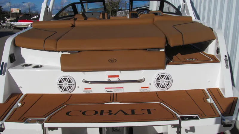 Slide: The Image of 2025 Cobalt CS23 boat with tan seating and branded deck. - 6
