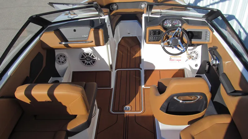 Slide: The Image of 2025 Cobalt CS23 boat interior with brown leather seats and modern dashboard. - 7