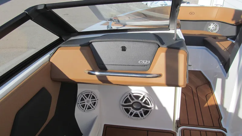 Slide: The Image of 2025 Cobalt CS23 boat interior with tan and black accents, featuring speakers and sleek design. - 9
