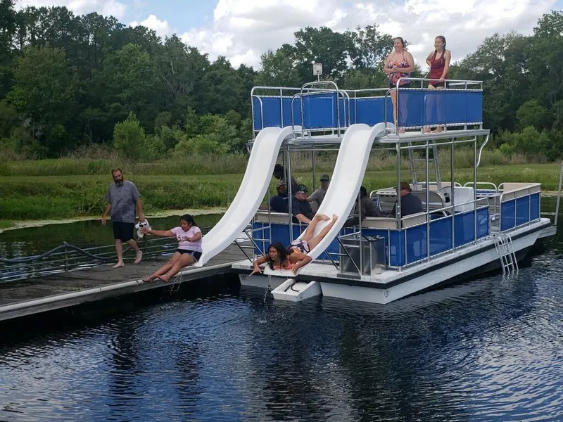 Slide: The Image of A&M Manufacturing Salty 28 DS boat with slides, people enjoying water activities, 2026 model. - 10