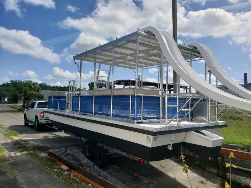 Slide: The Image of 2026 A&M Manufacturing Salty 28 DS boat with dual slides on a trailer under a blue sky. - 11