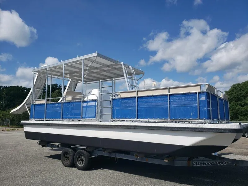 Slide: The Image of 2026 A&M Manufacturing Salty 28 DS boat on trailer under blue sky. - 12