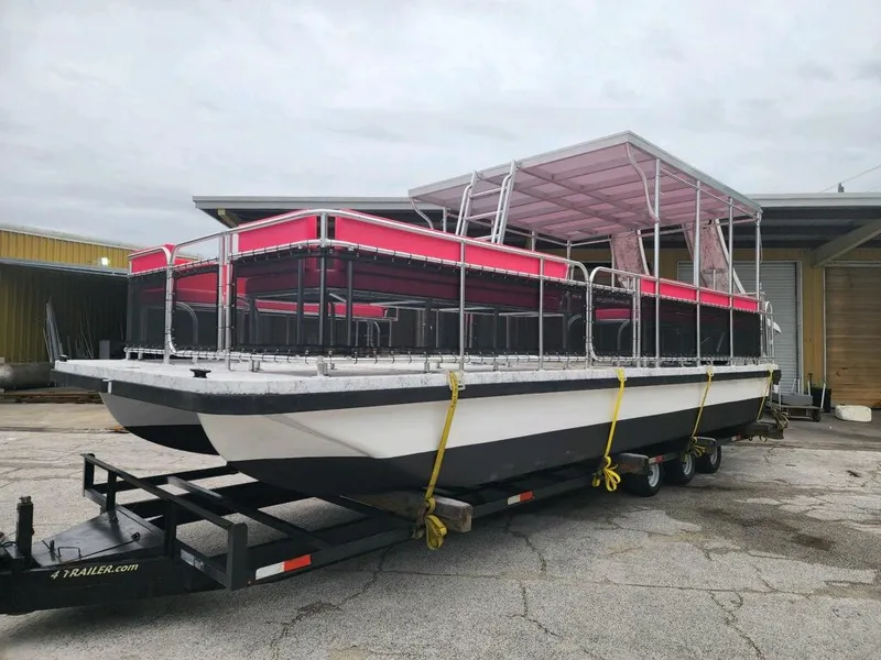 Slide: The Image of 2026 A&M Manufacturing Salty 28 DS pontoon boat on trailer, featuring red canopy. - 3