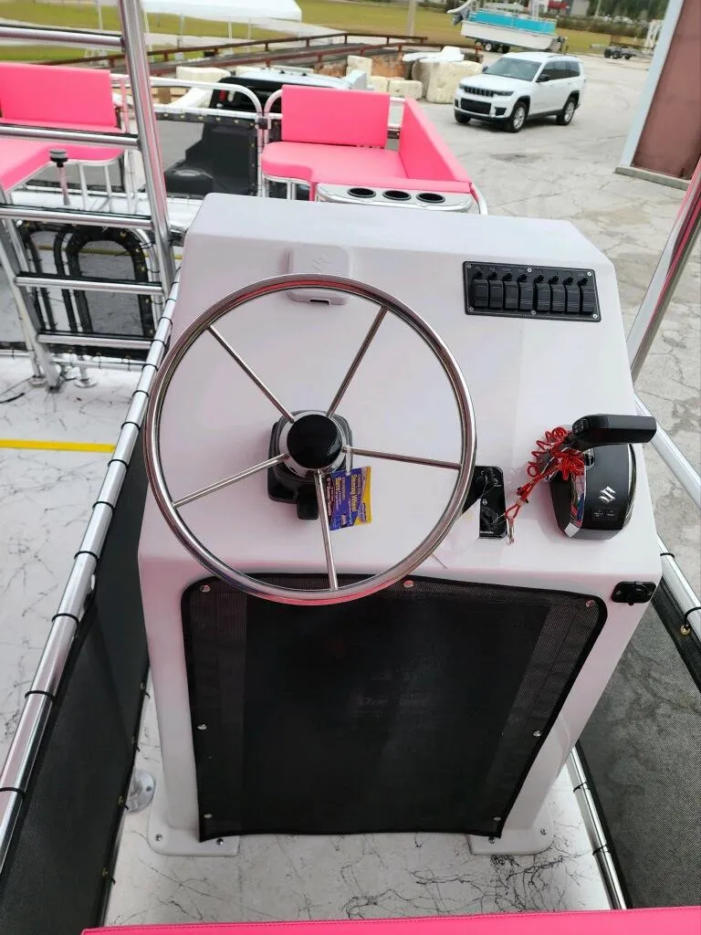Slide: The Image of Steering console of 2026 A&M Manufacturing Salty 28 DS boat with pink seating. - 6