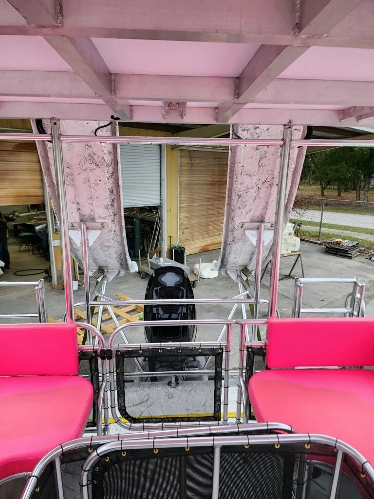Slide: The Image of Interior view of 2026 A&M Manufacturing Salty 28 DS boat with pink seating. - 7