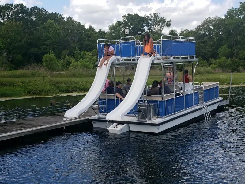 Slide: The Image of A&M Manufacturing Salty 28 DS pontoon boat with slides on a lake, 2026 model. - 9