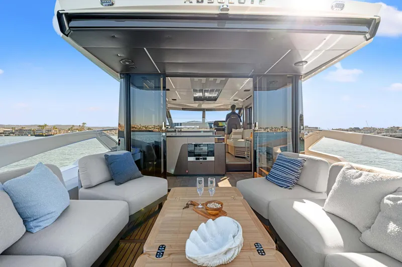 Slide: The Image of Luxurious 2026 Absolute 48 Coupe yacht interior with elegant seating and ocean view. - 17
