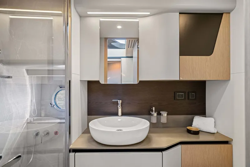 Slide: The Image of Luxurious bathroom interior of 2026 Absolute 48 Coupe yacht, featuring modern sink and cabinetry. - 41