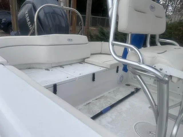 Slide: The Image of 2024 Sea Hunt Ultra 219 boat interior with seating and Yamaha engine. - 5