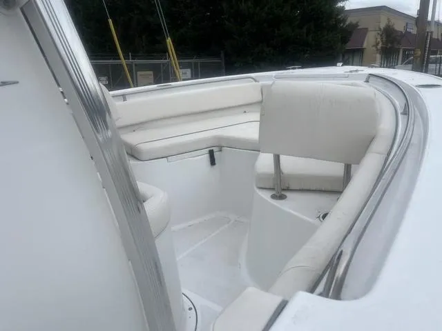 Slide: The Image of 2024 Sea Hunt Ultra 219 boat interior with white seating and spacious layout. - 6