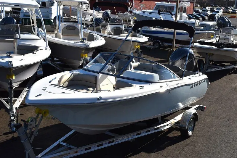 The Image of 2025 Key West 203 DFS boat on trailer, surrounded by other boats in a marina. - 1