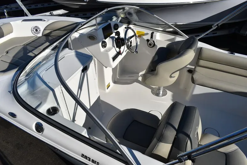 Slide: The Image of 2025 Key West 203 DFS boat interior with steering wheel and seating. - 16