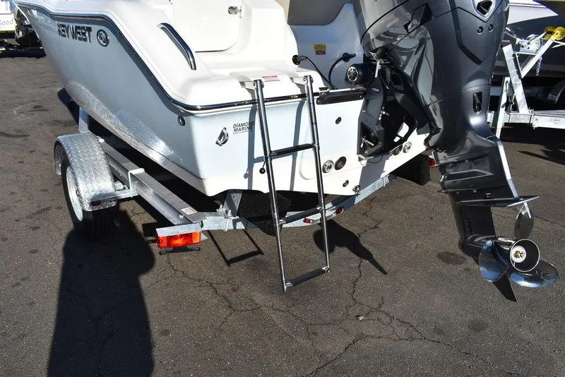 Slide: The Image of 2025 Key West 203 DFS boat on trailer with outboard motor and ladder. - 21