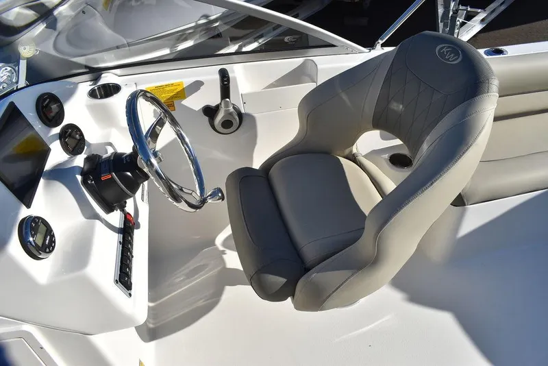 Slide: The Image of 2025 Key West 203 DFS boat cockpit with steering wheel and comfortable seating. - 30