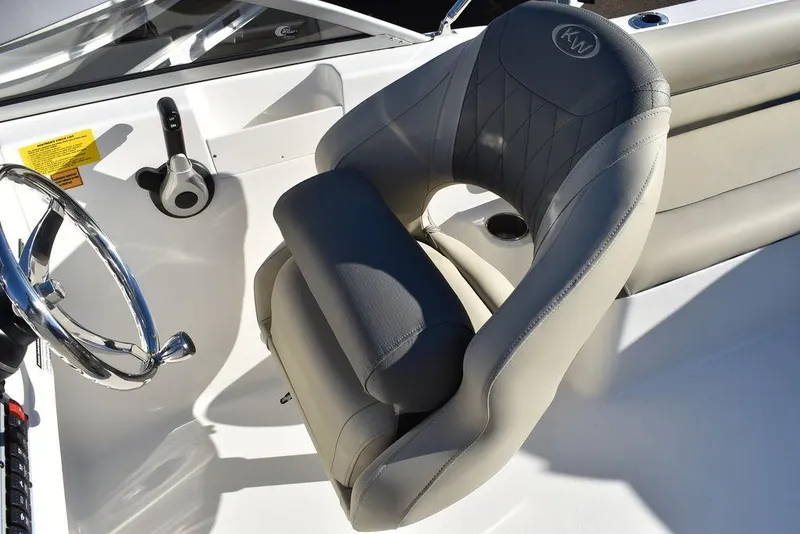 Slide: The Image of 2025 Key West 203 DFS boat interior with steering wheel and cushioned seat. - 31