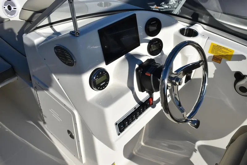 Slide: The Image of 2025 Key West 203 DFS boat dashboard with steering wheel and control panel. - 32