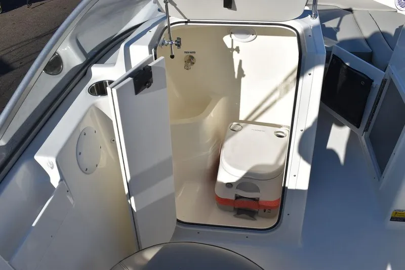 Slide: The Image of 2025 Key West 203 DFS boat interior with compact marine toilet. - 38