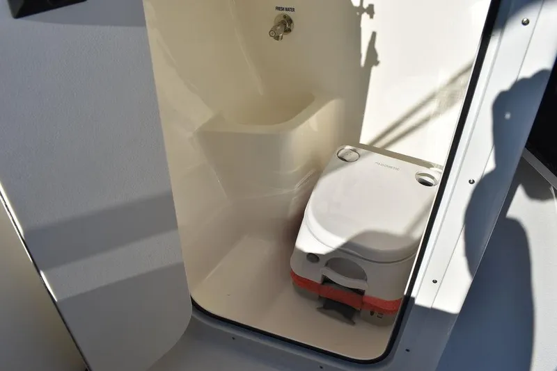Slide: The Image of 2025 Key West 203 DFS boat interior with compact marine toilet. - 40