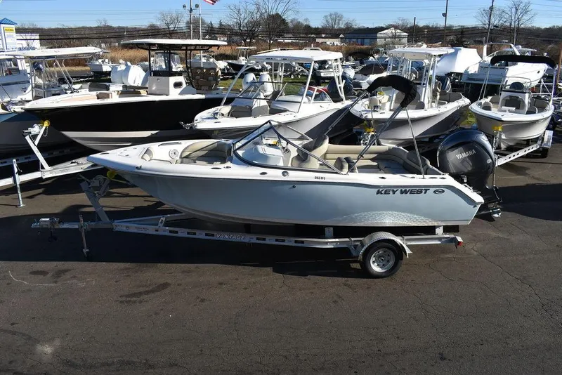 Slide: The Image of 2025 Key West 203 DFS boat on trailer in marina setting. - 8