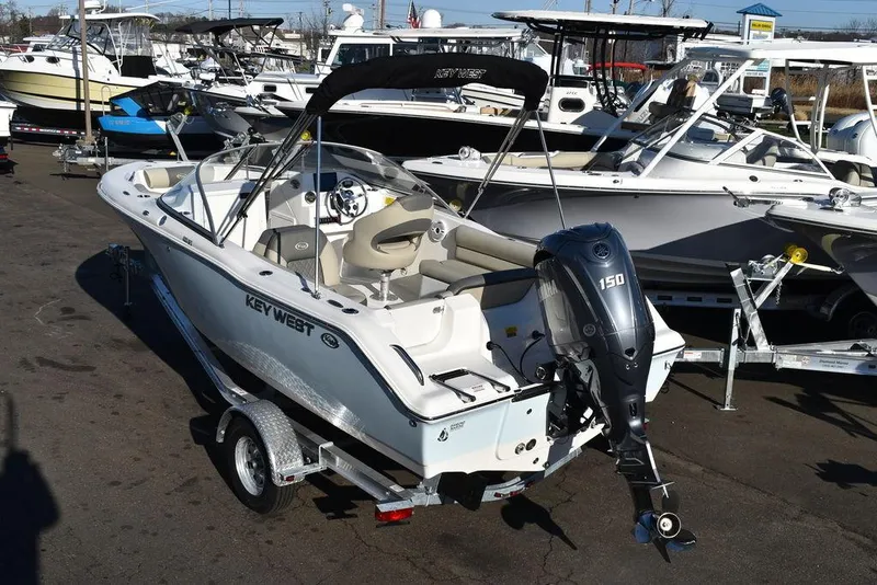 Slide: The Image of 2025 Key West 203 DFS boat with outboard motor on trailer in marina. - 9