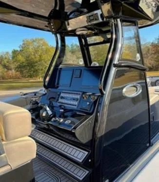 Slide: The Image of 2022 Tidewater 320 CC Adventure boat console with advanced controls and seating. - 4