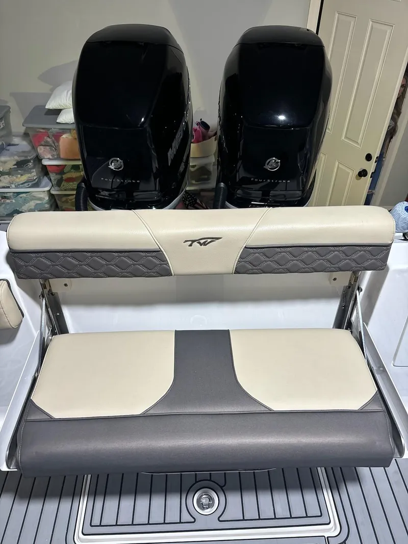 Slide: The Image of 2022 Tidewater 320 CC Adventure boat with dual engines and cushioned seating. - 5