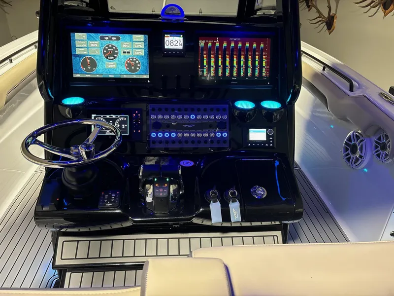 Slide: The Image of 2022 Tidewater 320 CC Adventure boat dashboard with advanced controls and displays. - 6