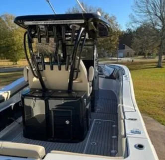 Slide: The Image of 2022 Tidewater 320 CC Adventure boat with sleek interior and fishing rod holders. - 9