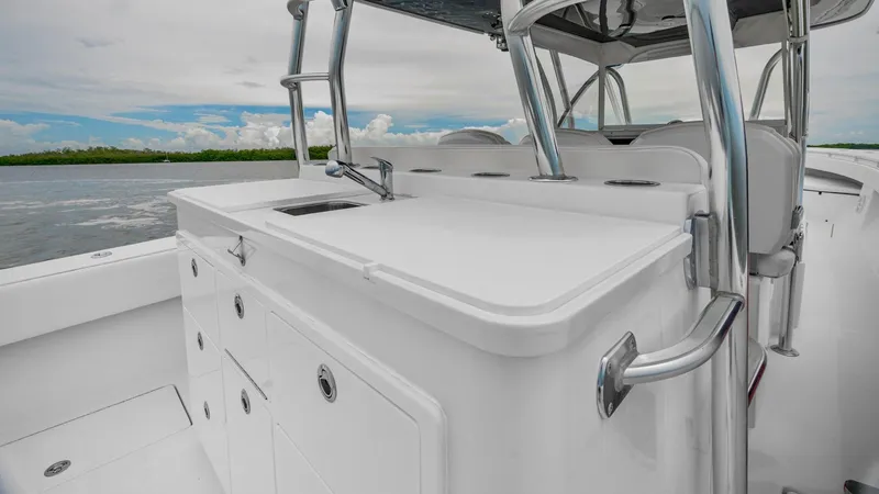 Slide: The Image of 2017 SeaHunter 45 Tournament boat interior with sleek white design and storage compartments. - 13