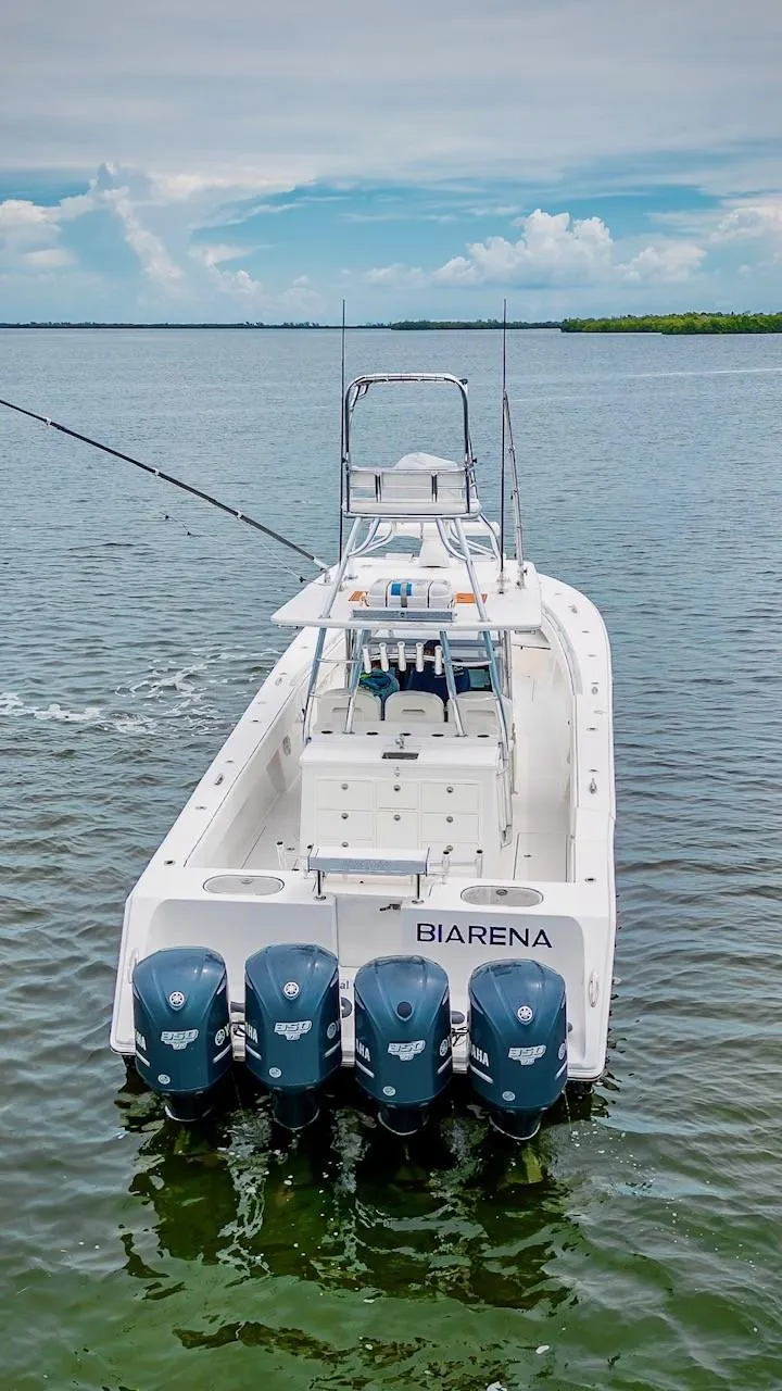 Slide: The Image of 2017 SeaHunter 45 Tournament boat with four engines on calm water. - 7