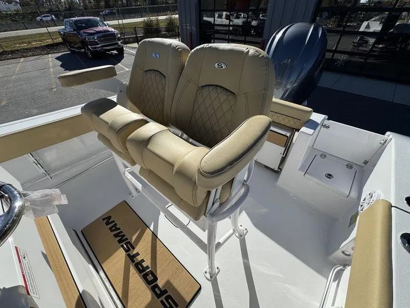 Slide: The Image of 2025 Sportsman Open 212 boat with beige cushioned seats and sleek design. - 12