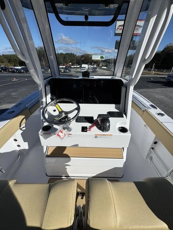 Slide: The Image of 2025 Sportsman Open 212 boat interior with steering wheel and dashboard controls. - 13