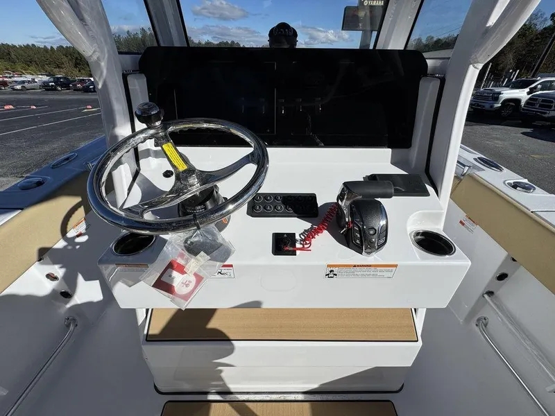 Slide: The Image of 2025 Sportsman Open 212 boat dashboard with steering wheel and controls. - 14