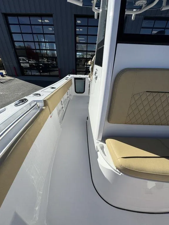 Slide: The Image of 2025 Sportsman Open 212 boat interior with tan seating and sleek design. - 17