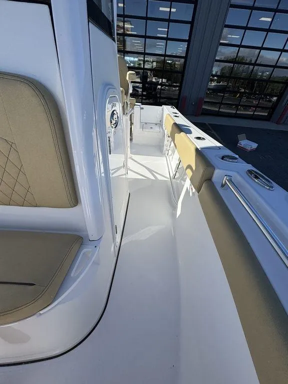 Slide: The Image of 2025 Sportsman Open 212 boat interior with beige seating and sleek white deck. - 19