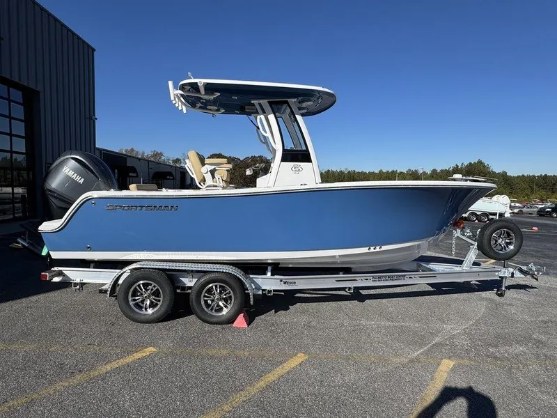 Slide: The Image of 2025 Sportsman Open 212 boat on trailer, blue hull, parked outdoors. - 3