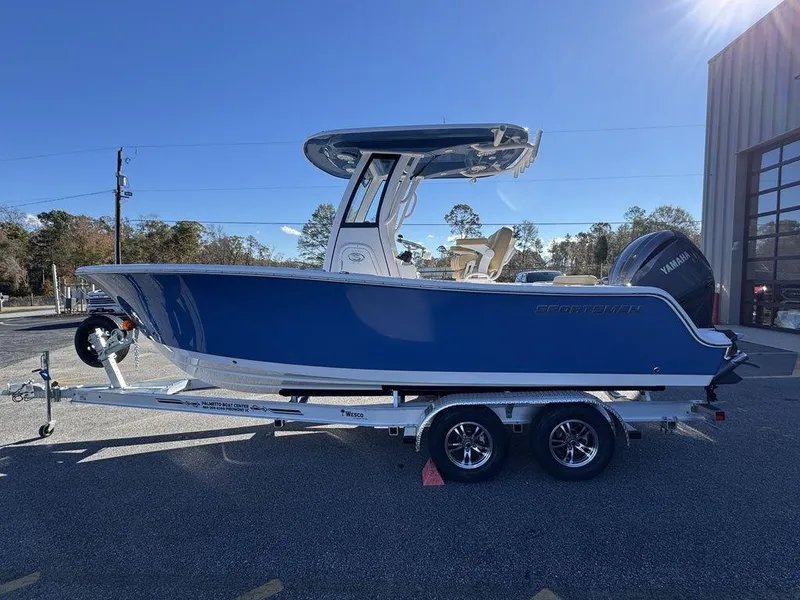 Slide: The Image of 2025 Sportsman Open 212 boat on trailer, blue hull, parked outdoors. - 6
