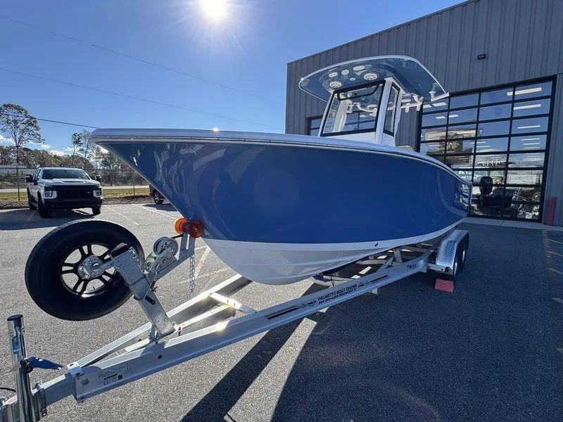 Slide: The Image of 2025 Sportsman Open 212 boat on trailer, parked outdoors in sunlight. - 7