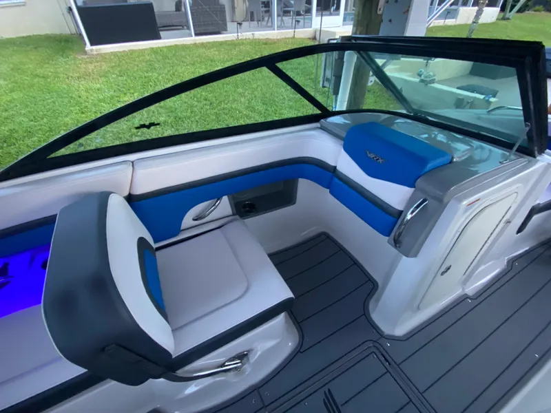 Slide: The Image of 2020 Chaparral 223 Vortex VRX boat interior with blue and white seating. - 11