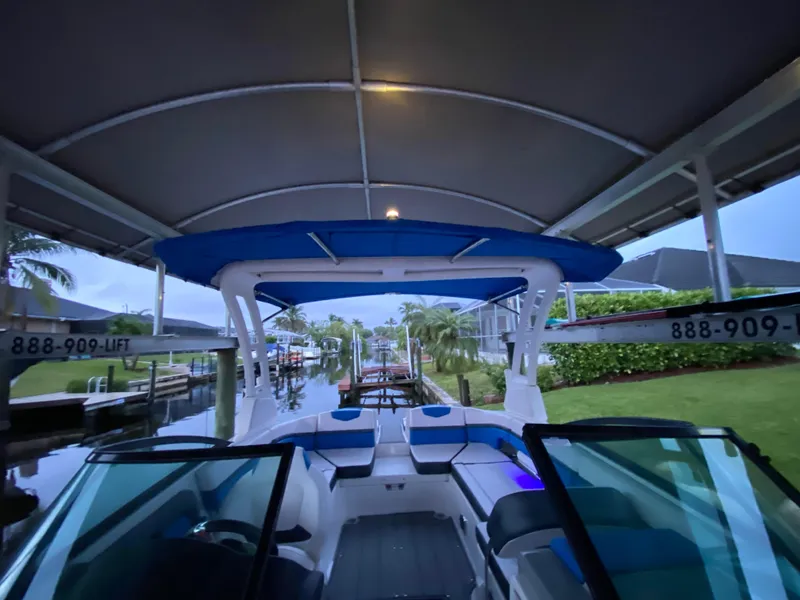Slide: The Image of 2020 Chaparral 223 Vortex VRX boat docked under canopy. - 15