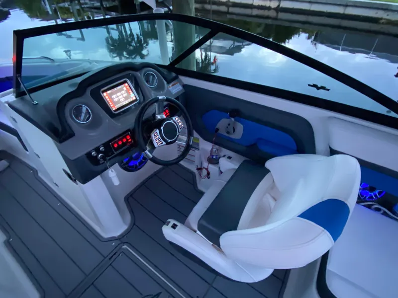 Slide: The Image of 2020 Chaparral 223 Vortex VRX boat cockpit with modern dashboard and comfortable seating. - 22