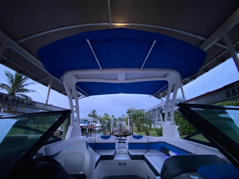 Slide: The Image of 2020 Chaparral 223 Vortex VRX boat interior with blue canopy and seating. - 24