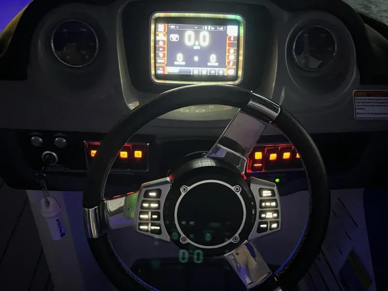 Slide: The Image of 2020 Chaparral 223 Vortex VRX dashboard with illuminated controls and digital display. - 28