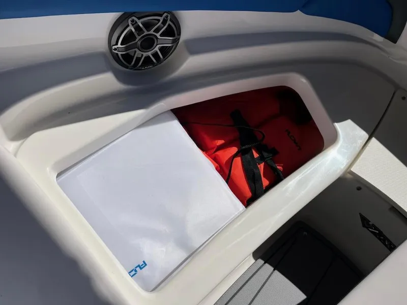 Slide: The Image of Storage compartment in 2020 Chaparral 223 Vortex VRX boat with speaker and life jacket. - 38